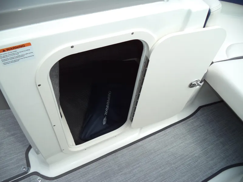 Slide: The Image of 2017 Chaparral Vortex 223 VR boat storage compartment with open door. - 24