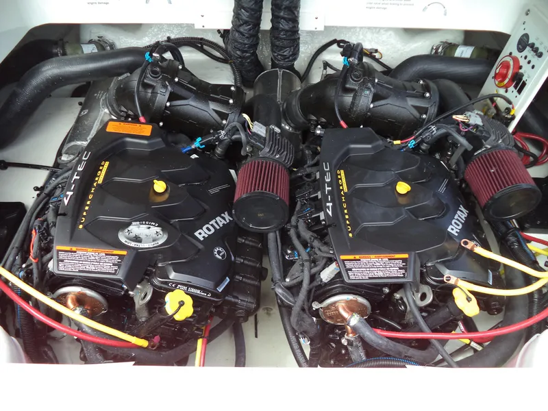 Slide: The Image of Twin Rotax engines in a 2017 Chaparral Vortex 223 VR boat engine compartment. - 27