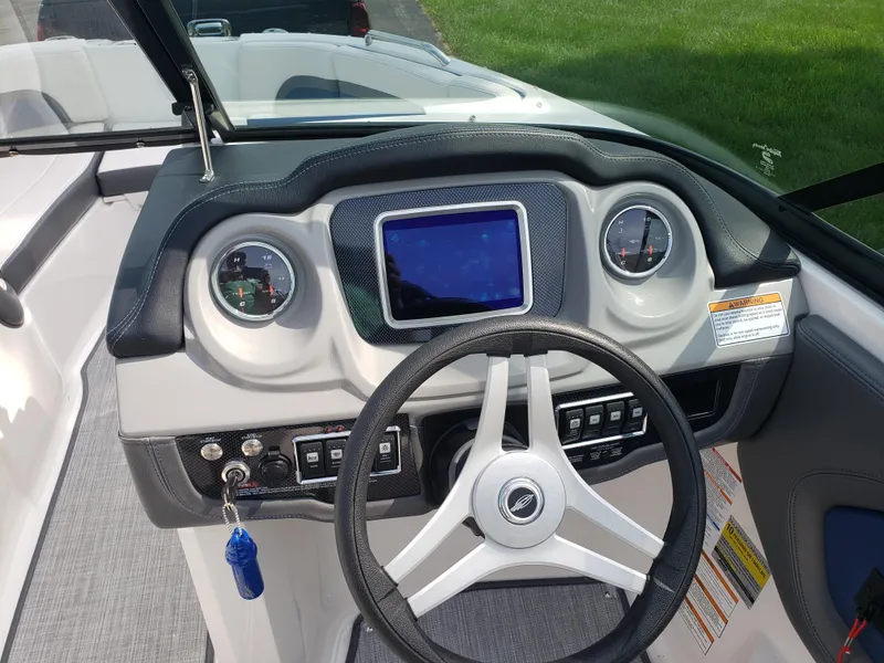 Slide: The Image of 2017 Chaparral Vortex 223 VR boat dashboard with steering wheel and gauges. - 8
