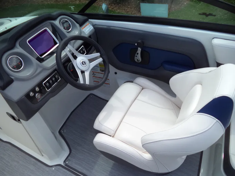 Slide: The Image of 2017 Chaparral Vortex 223 VR boat interior with steering wheel and white captain's seat. - 9