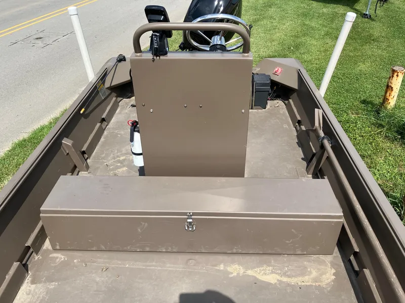 Slide: The Image of 2017 Pro-Drive SBX Series 18' boat interior with storage box and steering console. - 12