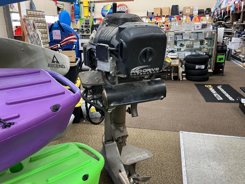 Slide: The Image of 2017 Pro-Drive SBX Series 18' outboard motor displayed in a store with colorful kayaks. - 20