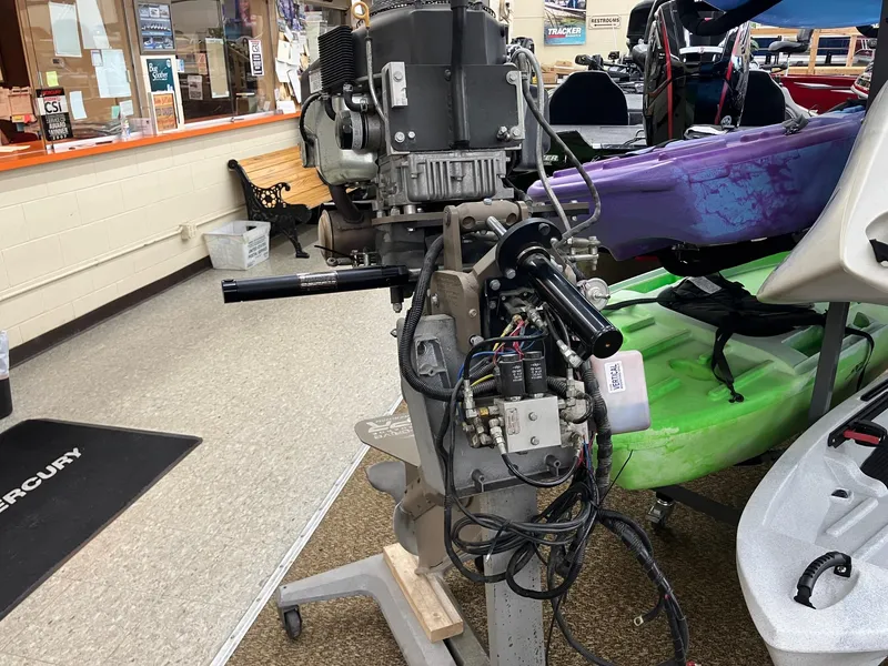 Slide: The Image of 2017 Pro-Drive SBX Series 18' boat motor in a showroom with kayaks. - 21