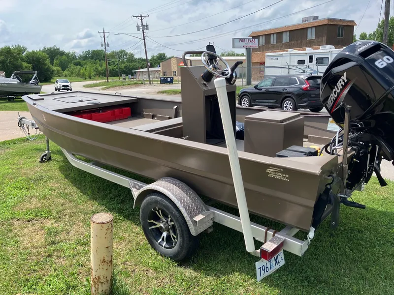 Slide: The Image of 2017 Pro-Drive SBX Series 18' boat with Mercury 60 engine on trailer, parked outdoors. - 3