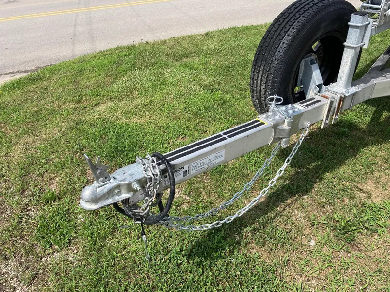 Slide: The Image of Trailer hitch of 2017 Pro-Drive SBX Series 18' on grass, showing chains and wheel. - 9