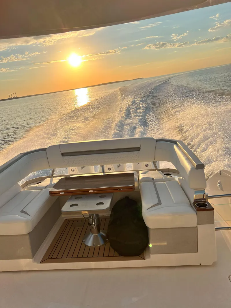 Slide: The Image of 2023 Tiara Yachts 38 LS cruising at sunset, leaving a wake on the water. - 5