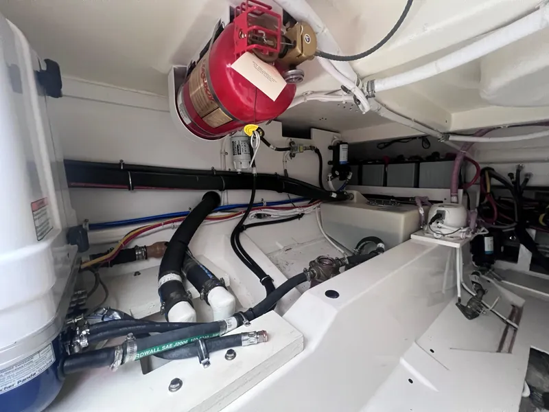 Slide: The Image of Engine compartment of 2023 Tiara Yachts 38 LS, featuring fire extinguisher and various mechanical components. - 6