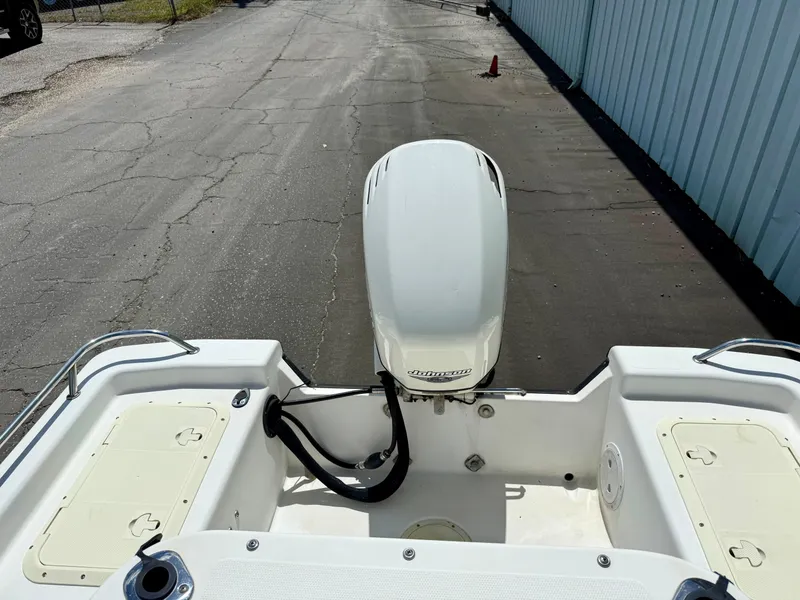 Slide: The Image of Kenner Vision 2102 boat, 2001 model, with Johnson outboard motor on a paved surface. - 10