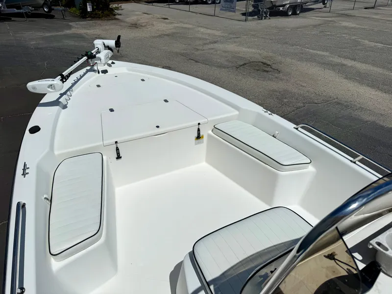 Slide: The Image of Kenner Vision 2102 boat, 2001 model, featuring white seating and deck, parked outdoors. - 5