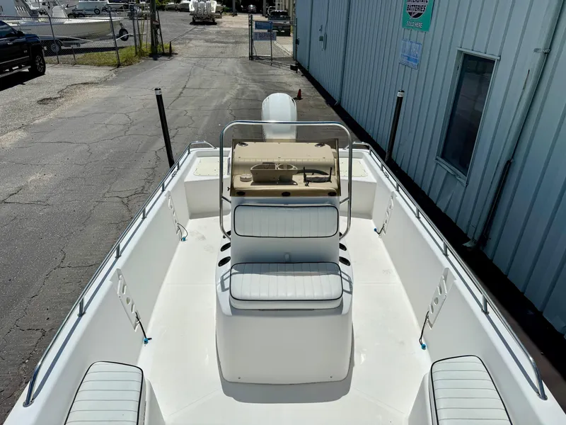 Slide: The Image of Kenner Vision 2102 boat, 2001 model, with white seating and console, docked outdoors. - 6