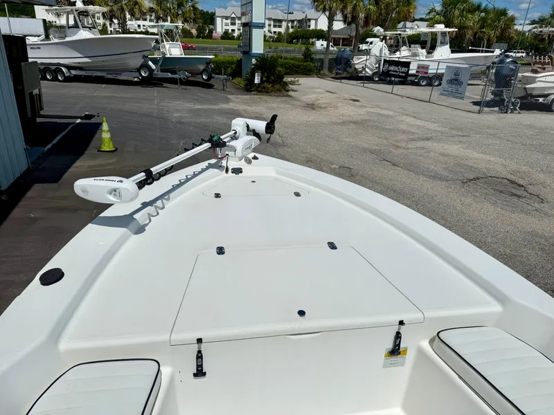 Slide: The Image of Kenner Vision 2102 boat deck, 2001 model, with trolling motor in a marina setting. - 8