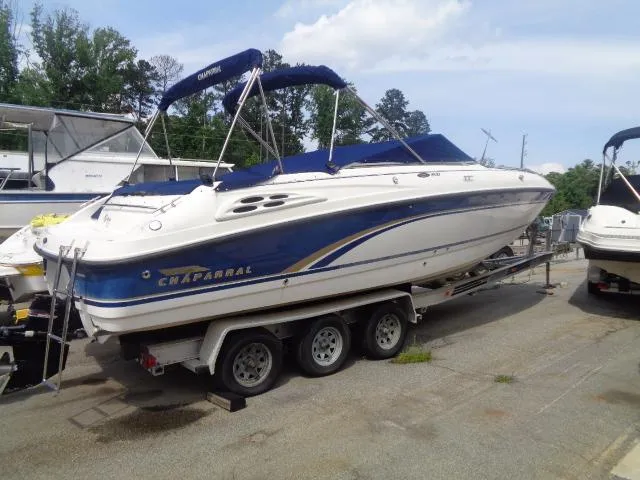 The Image of 1999 Chaparral 2830 Limited boat on trailer, blue and white design, parked outdoors. - 0