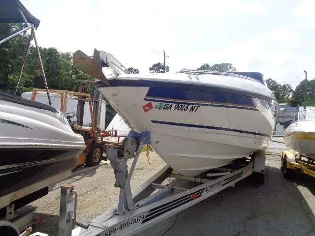 Slide: The Image of 1999 Chaparral 2830 Limited boat on trailer, parked outdoors, with visible registration number. - 11