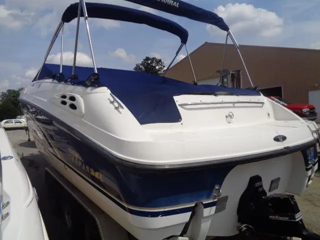Slide: The Image of 1999 Chaparral 2830 Limited boat with blue cover and canopy, parked outdoors. - 8