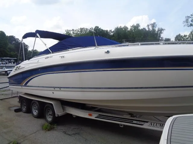 Slide: The Image of 1999 Chaparral 2830 Limited boat on trailer with blue canopy, parked outdoors. - 9