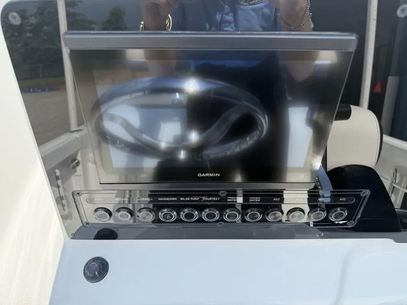 Slide: The Image of 2026 Tidewater 180 CC Adventure boat dashboard with Garmin display and control panel. - 10