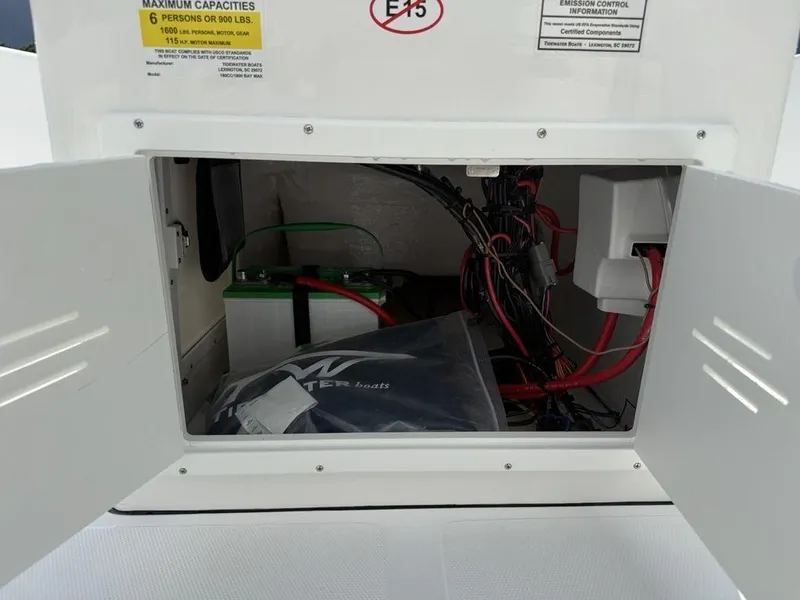 Slide: The Image of Open compartment of 2026 Tidewater 180 CC Adventure boat showing battery and wiring. - 18