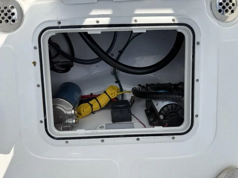 Slide: The Image of 2026 Tidewater 180 CC Adventure boat storage compartment with equipment and wiring. - 21
