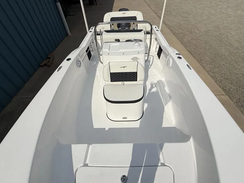 Slide: The Image of 2026 Tidewater 180 CC Adventure boat, white interior, sleek design, docked outdoors. - 27