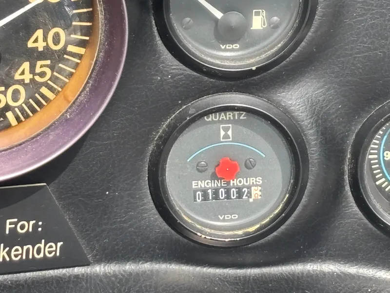 Slide: The Image of 1989 Correct Craft Ski Nautique dashboard showing engine hours and fuel gauge. - 12