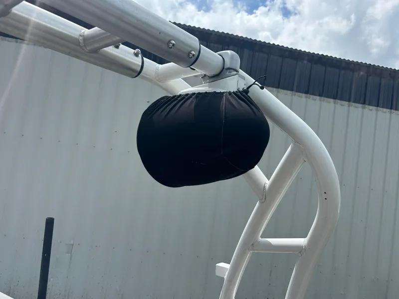 Slide: The Image of 1989 Correct Craft Ski Nautique boat tower with black cover against a cloudy sky. - 16