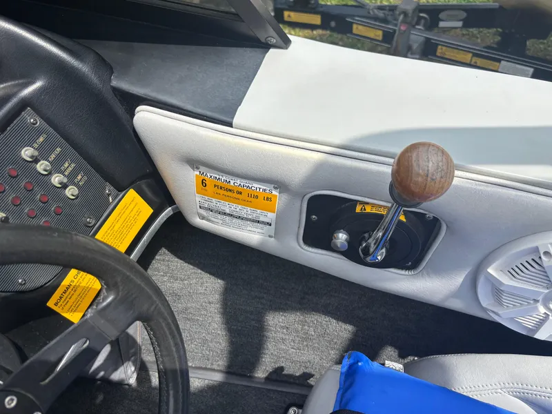 Slide: The Image of 1989 Correct Craft Ski Nautique dashboard with steering wheel, controls, and capacity label. - 17