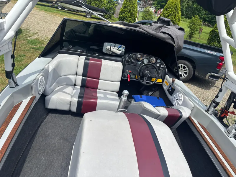 Slide: The Image of 1989 Correct Craft Ski Nautique interior with maroon and white seating, dashboard, and steering wheel. - 5
