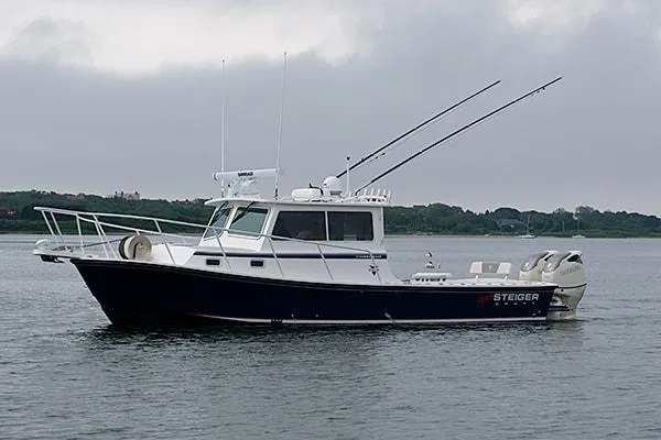 The Image of 2026 Steiger Craft 31 Miami boat on calm water, overcast sky. - 1