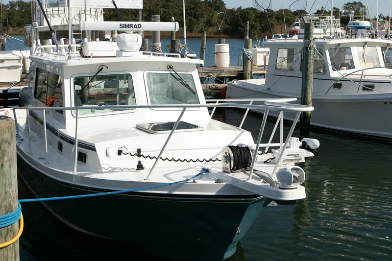 Slide: The Image of 2026 Steiger Craft 31 Miami boat docked in marina, featuring advanced navigation equipment. - 15