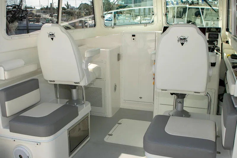 Slide: The Image of 2026 Steiger Craft 31 Miami boat interior with white seating and control area. - 28