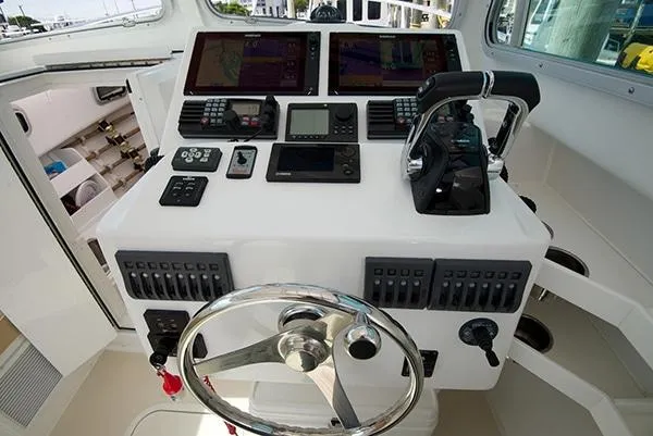 Slide: The Image of 2026 Steiger Craft 31 Miami boat dashboard with advanced navigation controls and steering wheel. - 30