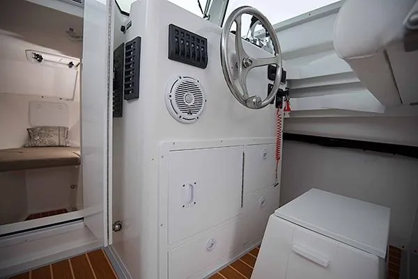 Slide: The Image of 2026 Steiger Craft 31 Miami boat interior with steering wheel and cabin view. - 33