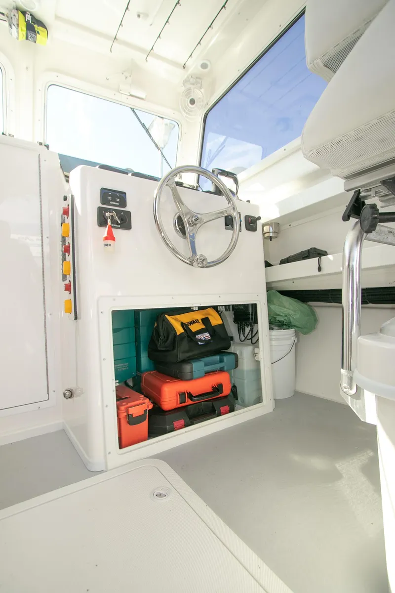 Slide: The Image of Steiger Craft 31 Miami 2026 boat interior with steering wheel and storage area. - 34