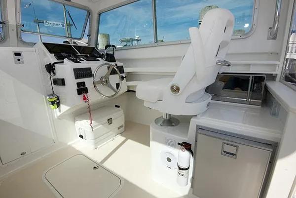 Slide: The Image of Interior of 2026 Steiger Craft 31 Miami boat with helm, captain's chair, and navigation equipment. - 36
