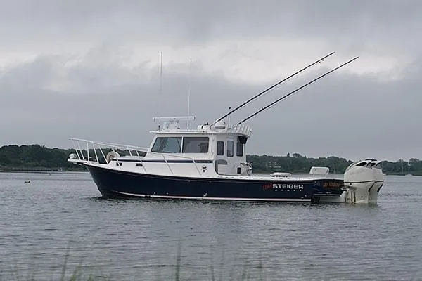 Slide: The Image of 2026 Steiger Craft 31 Miami boat on calm water under cloudy sky. - 4