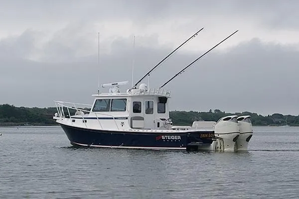 Slide: The Image of 2026 Steiger Craft 31 Miami boat on calm water, overcast sky. - 5