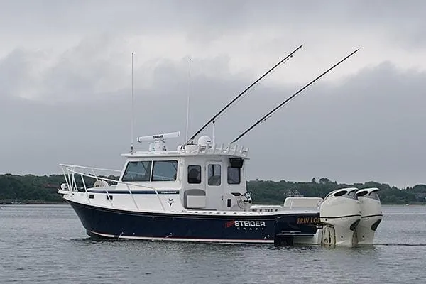 Slide: The Image of 2026 Steiger Craft 31 Miami boat on calm water, overcast sky. - 6