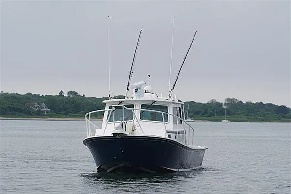 Slide: The Image of 2026 Steiger Craft 31 Miami boat on calm water, overcast sky in the background. - 7