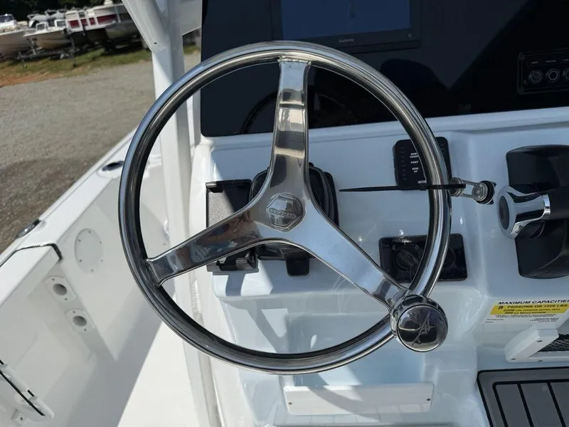 Slide: The Image of Steering wheel of 2026 Tidewater 2110 BM boat, featuring sleek chrome design. - 15