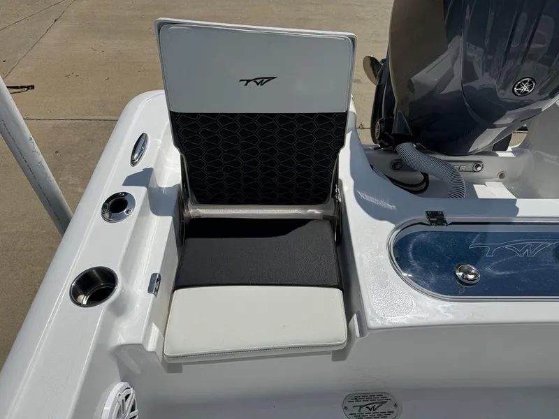 Slide: The Image of 2026 Tidewater 2110 BM boat seat and motor detail, featuring cup holders and storage. - 20