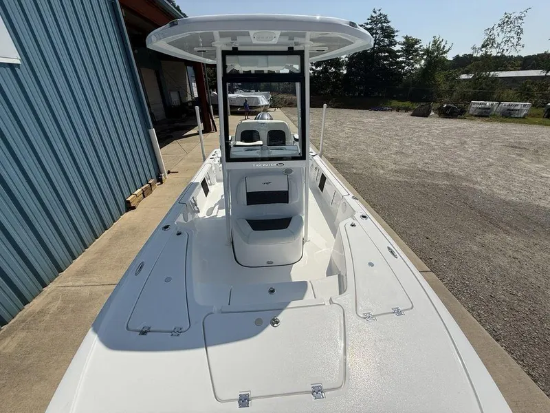 Slide: The Image of 2026 Tidewater 2110 BM boat, white deck, docked near a blue building. - 22