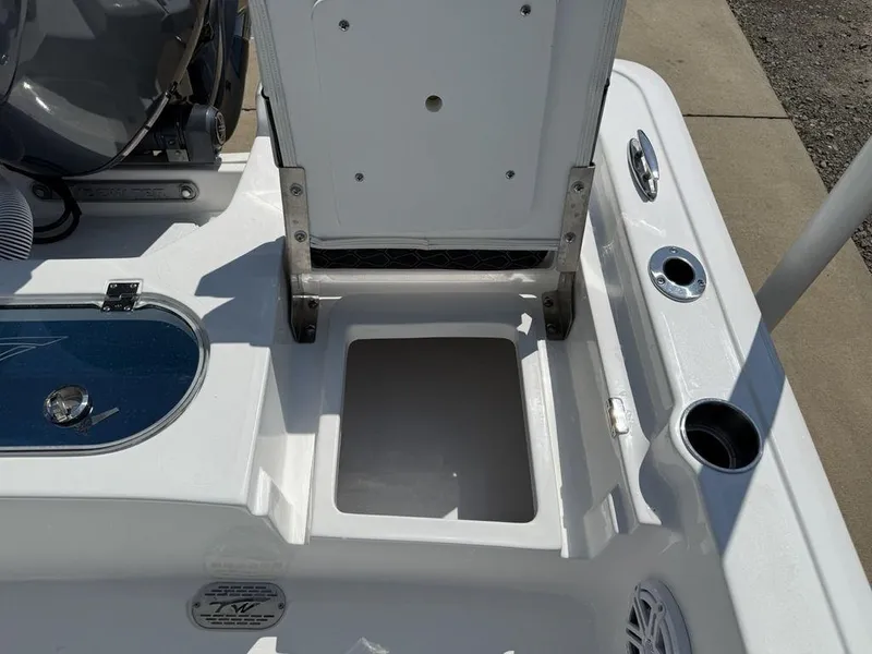 Slide: The Image of 2026 Tidewater 2110 BM boat interior showing storage compartment and cup holders. - 24