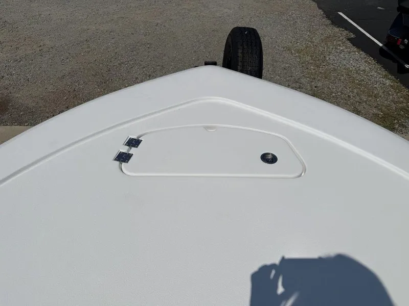 Slide: The Image of 2026 Tidewater 2110 BM boat deck with storage compartment and trailer wheel visible. - 3