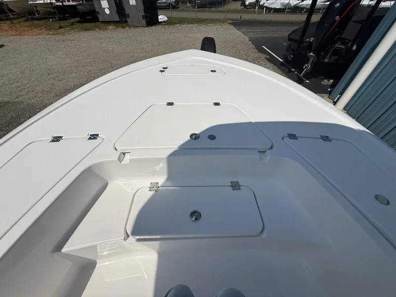 Slide: The Image of 2026 Tidewater 2110 BM boat deck with storage compartments, parked outdoors. - 5
