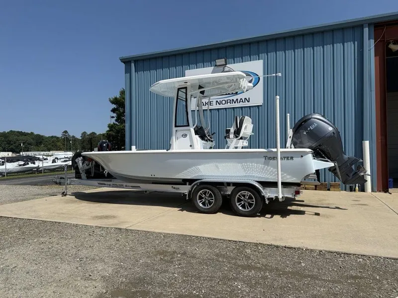 Slide: The Image of 2026 Tidewater 2110 BM boat on trailer, parked outside Lake Norman building. - 7