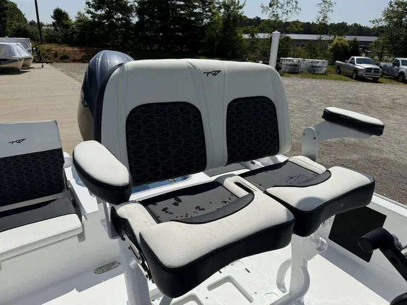 Slide: The Image of 2026 Tidewater 2110 BM boat seats with black and white upholstery, parked outdoors. - 8