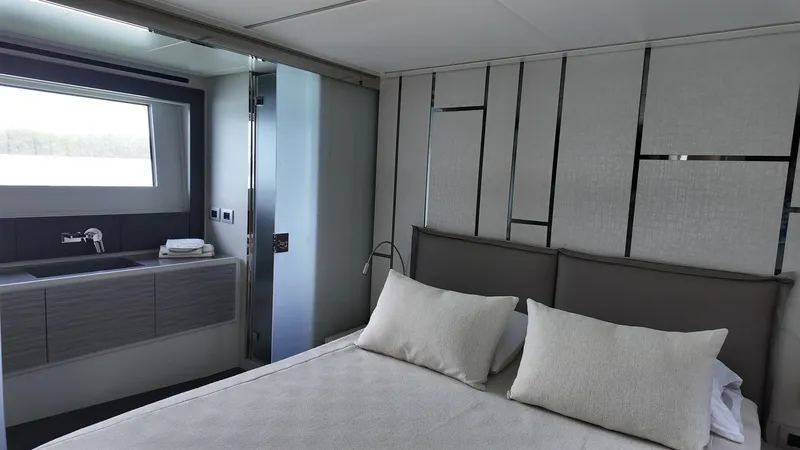Slide: The Image of Luxurious bedroom interior of 2022 Pershing 6X yacht with modern design and elegant decor. - 12