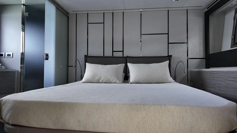 Slide: The Image of Luxurious bedroom interior of 2022 Pershing 6X yacht with modern design elements. - 13