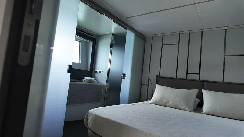 Slide: The Image of Luxurious bedroom interior of 2022 Pershing 6X yacht with modern design and elegant decor. - 14