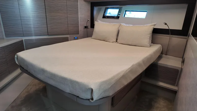 Slide: The Image of Luxurious bedroom interior of 2022 Pershing 6X yacht with modern design and comfortable bedding. - 23
